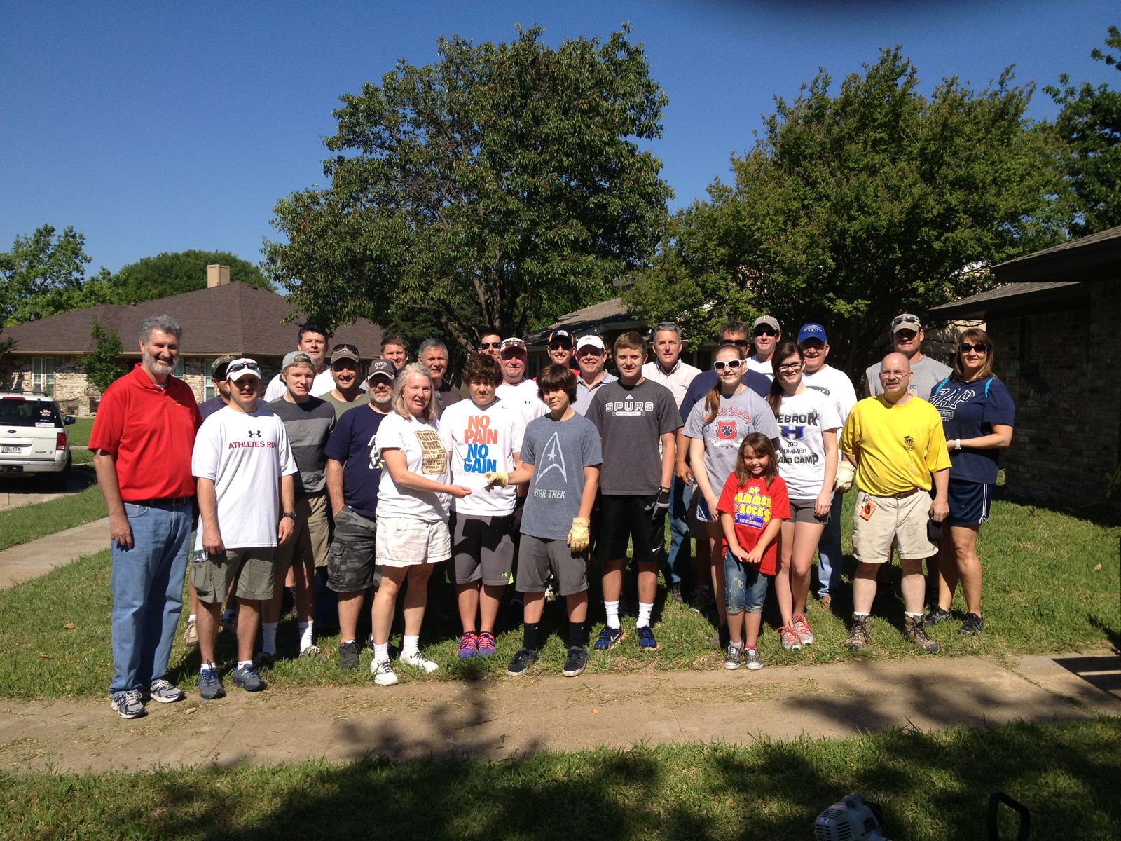 The Honey Dudes volunteer crew gathered on a lawn before a workday